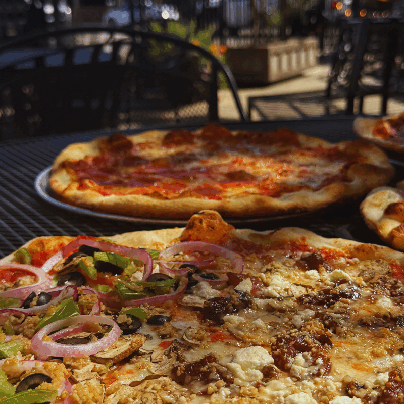 Boise patio season|Wiseguy Pizza Pie Boise|sunny outdoor dining Boise|hand tossed pizza Idaho|stone deck oven pizza|cold local draft beer|best Boise pizza patios|funny snarky food blog